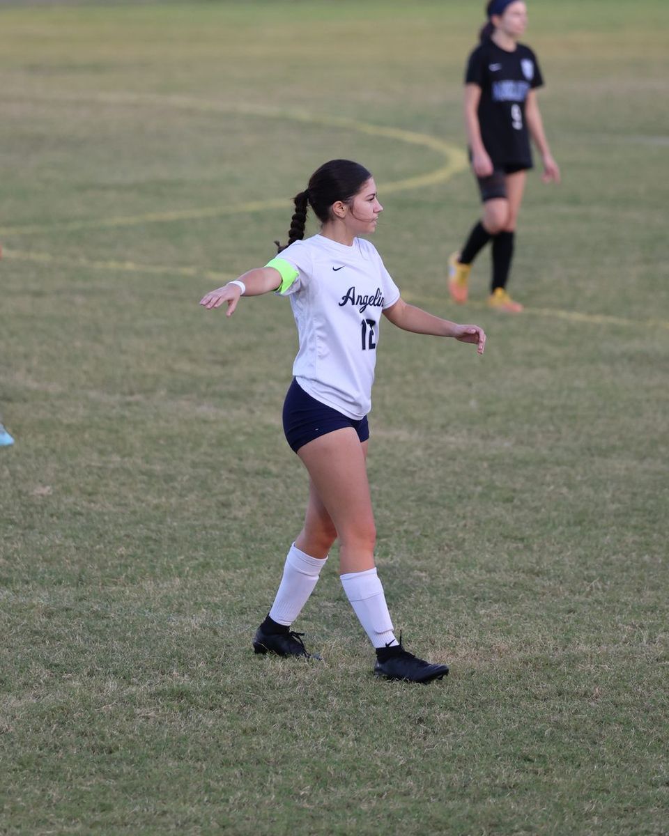 Eva Lowe, wearing the captain armband and number 12, directs teammates during Angeline Academy vs. Anclote
